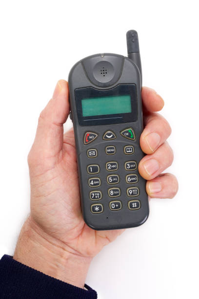 istock Hand holding a retro cell phone from the late 90's. 1129375765
