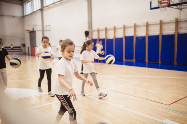 istock Female volleyball team exercising indoors 1129378856
