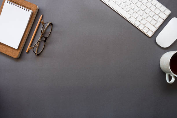 istock Home office desk over glasses, keyboard, mouse, pencil, notepad and coffee 1129378869