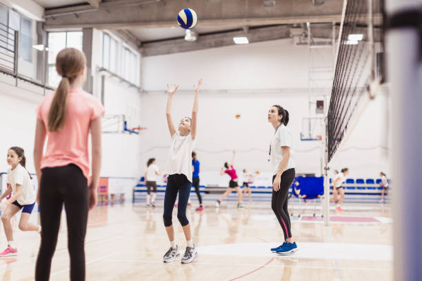 istock Female volleyball team exercising indoors 1129378898