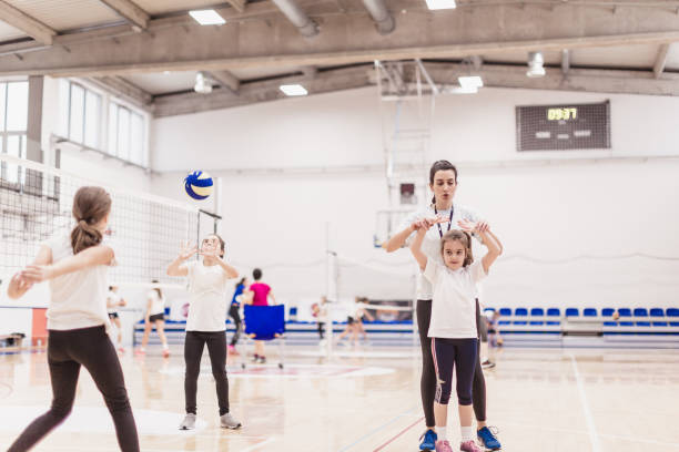 istock Female volleyball team exercising with coach 1129378926