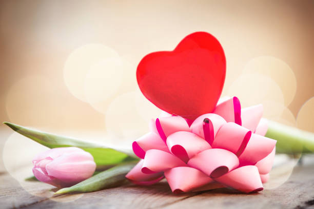 Romantic pink tulip and red heart background