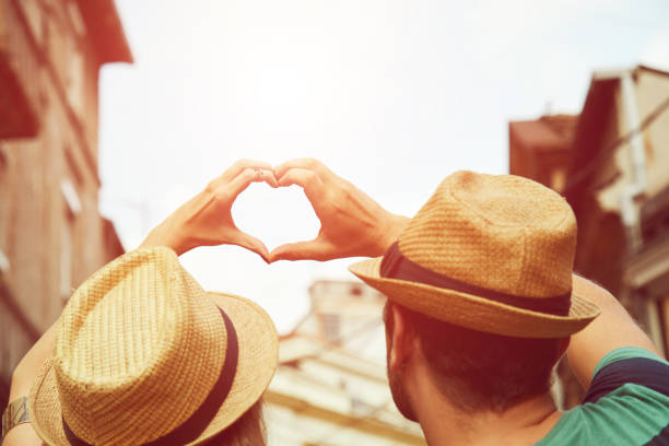 istock Couple in love make heart-shape with hands. Love concept. 1129381531