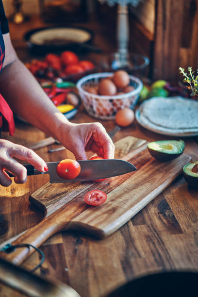 istock Preparing Mexican Style Breakfast with Eggs, Beans, Tomatoes, Avocado and Chili 1129381754