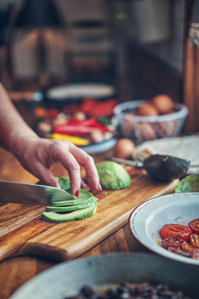 istock Preparing Mexican Style Breakfast with Eggs, Beans, Tomatoes, Avocado and Chili 1129381756