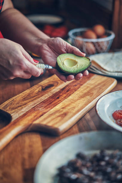 istock Preparing Mexican Style Breakfast with Eggs, Beans, Tomatoes, Avocado and Chili 1129381761