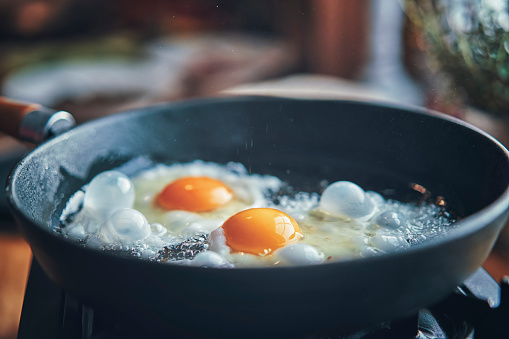 Frying Egg in a Cooking Pan in Domestic Kitchen