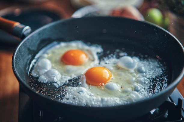 istock Frying Egg in a Cooking Pan in Domestic Kitchen 1129381769