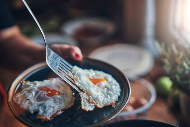 istock Frying Egg in a Cooking Pan in Domestic Kitchen 1129381778