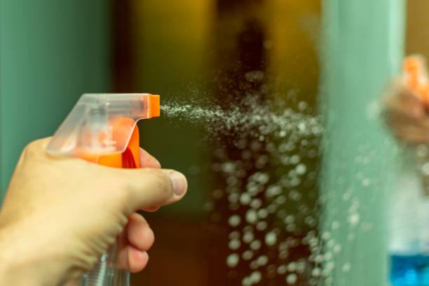 istock wash spray glass by spraying detergent onto the mirror 1129382209