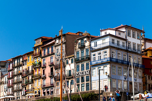 Porto, Portugal - September 27th, 2014: Historic house facades in the old city center on the banks of the Douro River with the building of the big Portwine Merchant Bodegas Calem amidst