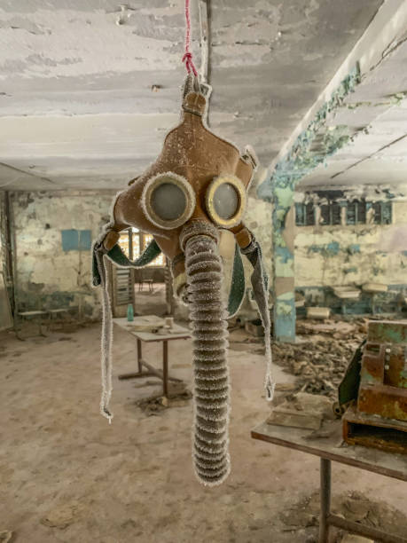 Gas mask hanging in abandoned school near Chernobyl Gas mask hanging in abandoned school in Pripyat, Ukraine pripyat city stock pictures, royalty-free photos & images
