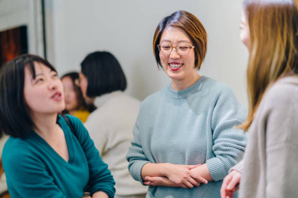 istock Three women enjoying talking to each other in cafe 1129384775