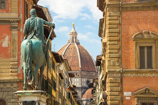 Cathedral of Santa Maria del Fiore and Monument of Cosimo de Medici. View from the Piazza of the Santissima Annunziata. Beautiful sunny day in Florence, Italy.