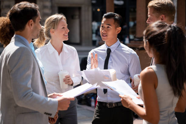 istock Happy business group working together outdoors 1129386370