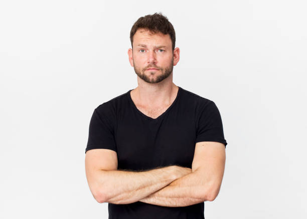 istock Handsome man in black portrait against white background 1129386658