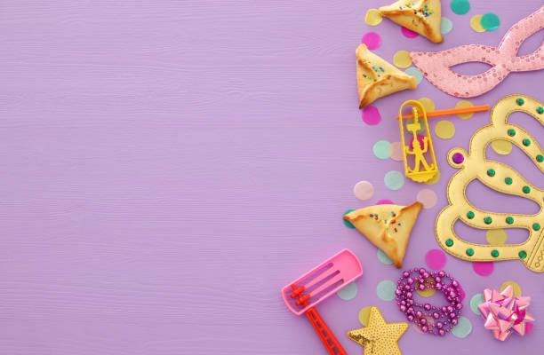 istock Purim celebration concept (jewish carnival holiday) over wooden pink background 1129386817
