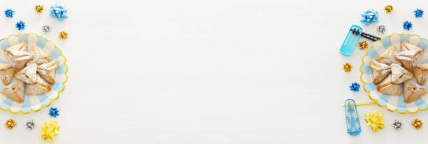 istock Purim celebration concept (jewish carnival holiday) over wooden white background. 1129387447