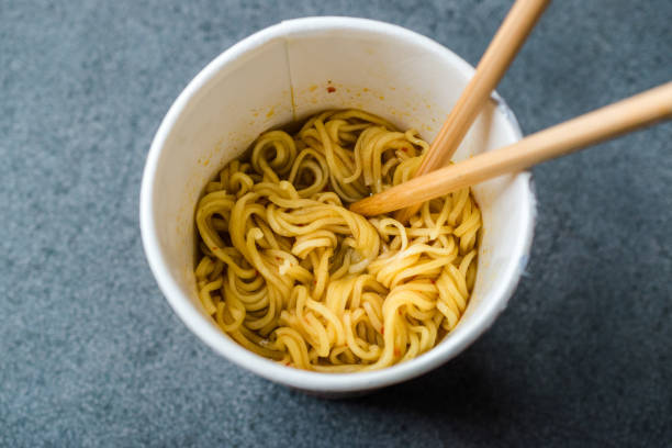 istock Instant Curry Flavored Ramen Noodles served with Chopsticks. in Plastic Cup 1129389667