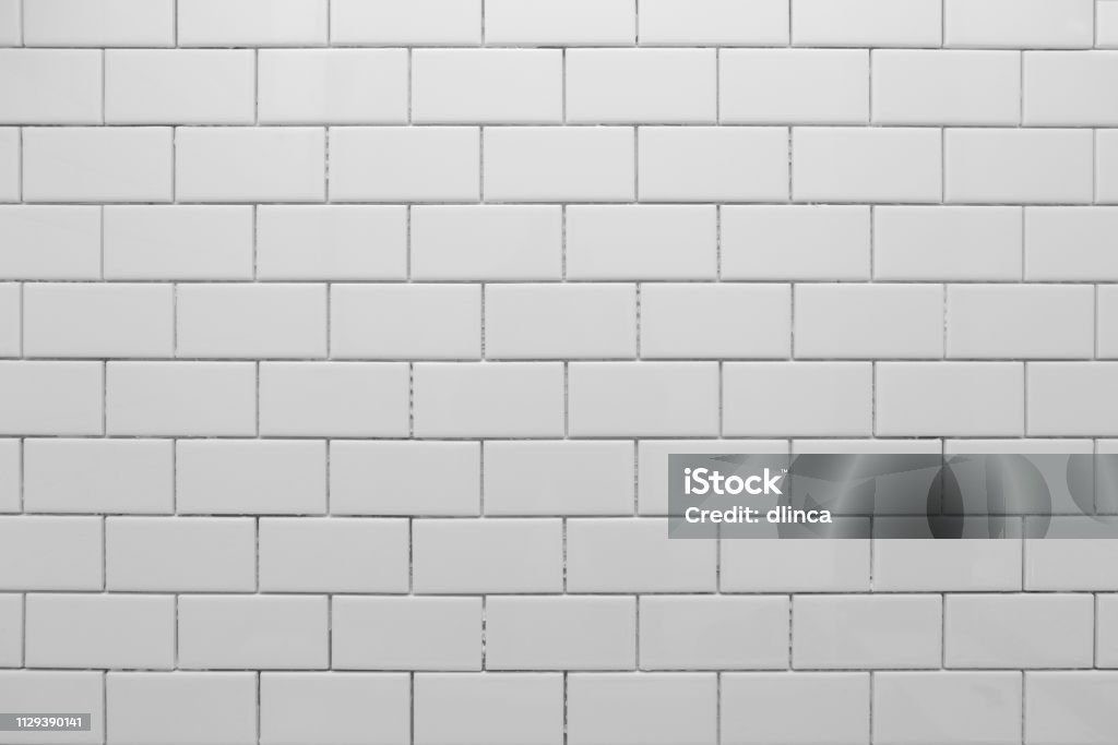 White subway tile without grout White subway tile, freshly installed, waiting for grout. Tile Stock Photo