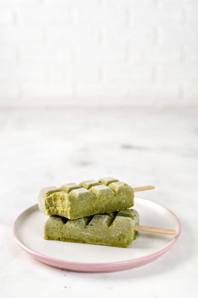 istock Three green vegan sorbet popsicles on white background 1129391390