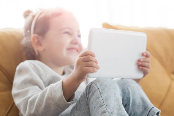 istock Toddler girl using digital tablet 1129391576