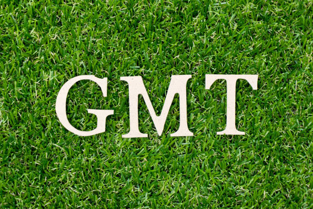 istock Wood letter block in word GMT (abbreviation of Greenwich Mean Time) on artificial green grass background 1129391663
