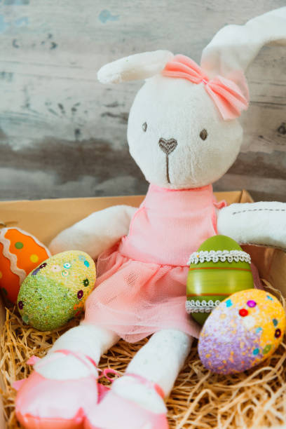 istock Easter rabbit and eggs with colorful eggs around and white background 1129391671
