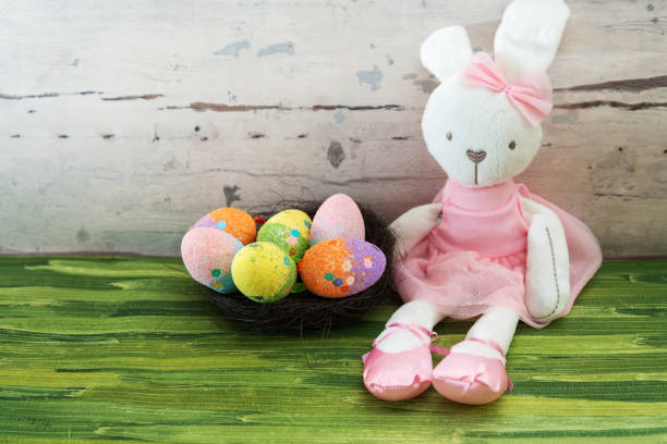 istock Easter rabbit and eggs with colorful eggs around and white background 1129391761