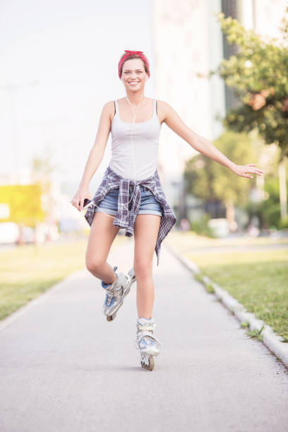 istock Young woman with rollerblades outdoors 1129396007