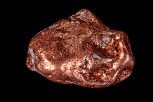 istock Macro mineral stone of a copper nugget on a microcline on a black background 1129396688