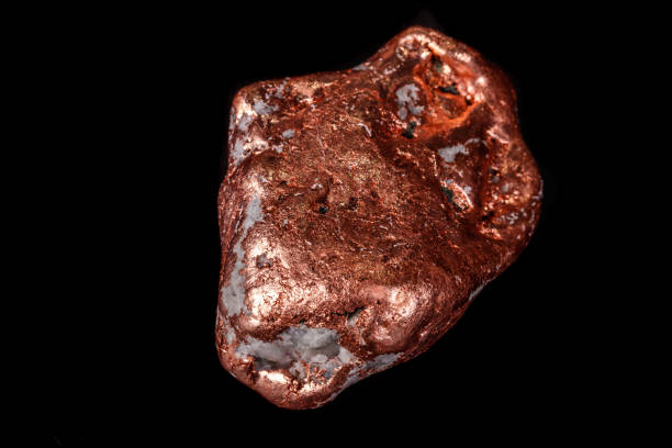 istock Macro mineral stone of a copper nugget on a microcline on a black background 1129396695