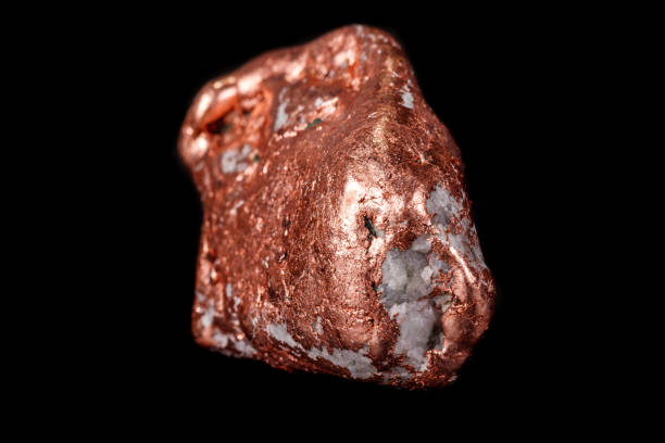 istock Macro mineral stone of a copper nugget on a microcline on a black background 1129396720