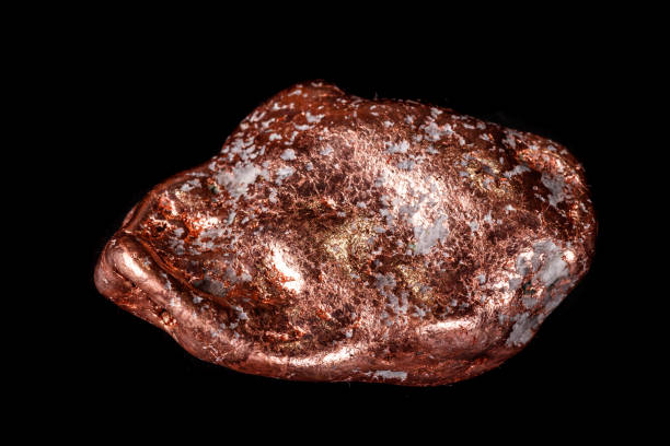 istock Macro mineral stone of a copper nugget on a microcline on a black background 1129396875