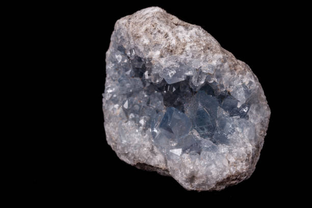 istock Celestine mineral stone macro on microcline on black background 1129397107