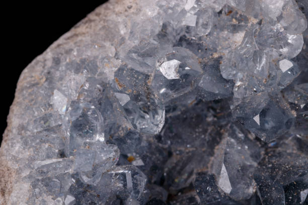 istock Celestine mineral stone macro on microcline on black background 1129397154