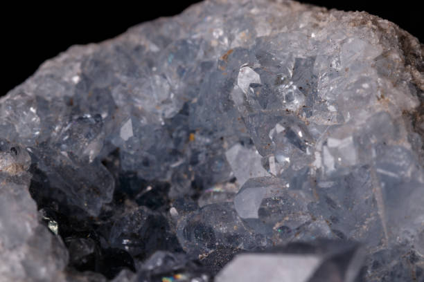 istock Celestine mineral stone macro on microcline on black background 1129397703