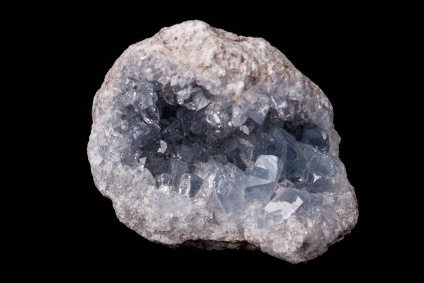 istock Celestine mineral stone macro on microcline on black background 1129397977