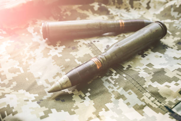 istock Shell missile is lying on the old khaki jacket. Historical things on armored fighting vehicle. 1129398032