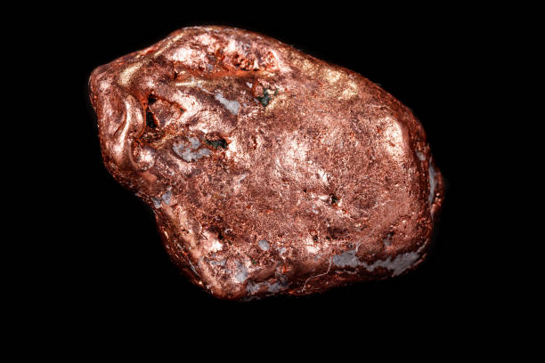 istock Macro mineral stone of a copper nugget on a microcline on a black background 1129398053