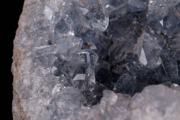 istock Celestine mineral stone macro on microcline on black background 1129398109