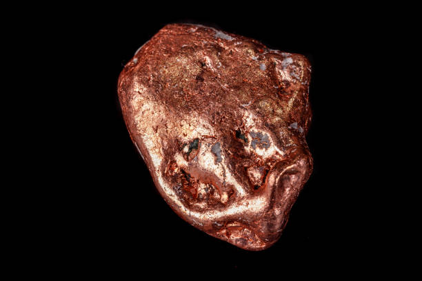 istock Macro mineral stone of a copper nugget on a microcline on a black background 1129398143