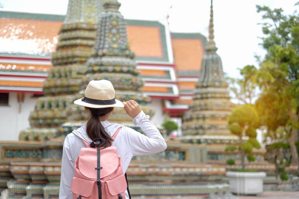 istock Rear View Of Woman With Backpack Looking At Temple 1129398285