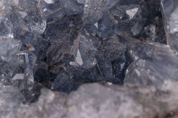 istock Celestine mineral stone macro on microcline on black background 1129398319
