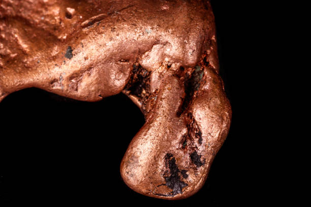 istock Macro mineral stone of a copper nugget on a microcline on a black background 1129398466