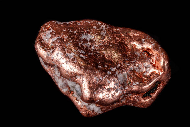 istock Macro mineral stone of a copper nugget on a microcline on a black background 1129398549