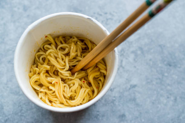 istock Instant Curry Flavored Ramen Noodles served with Chopsticks. in Plastic Cup 1129398611