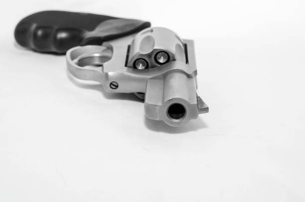 istock A loaded 357 magnum revolver on its side on a white background 1129398677