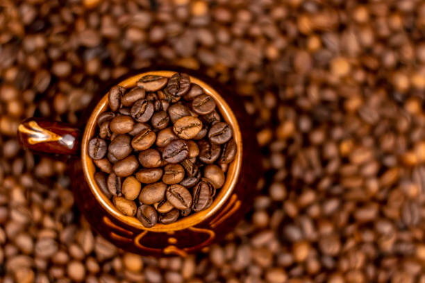 istock Cup of coffee beans, on old rusty background. Soft focus, copy space. 1129399042