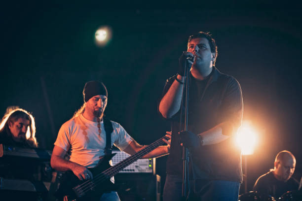 istock Rock and roll band performing hard rock music on stage 1129402166